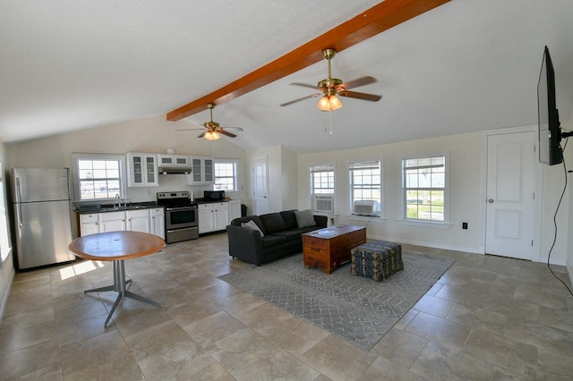 living room featuring sink and lofted ceiling with beams