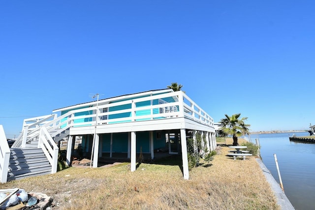 rear view of property featuring a water view