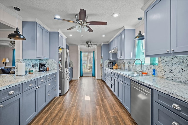 kitchen featuring appliances with stainless steel finishes, dark hardwood / wood-style floors, sink, and hanging light fixtures