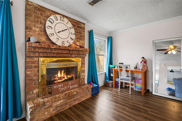 interior space featuring hardwood / wood-style flooring, crown molding, a brick fireplace, and a textured ceiling