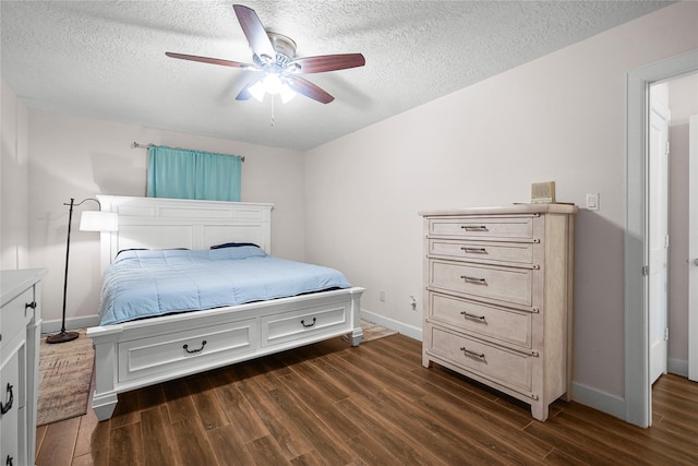 bedroom featuring ceiling fan, dark wood-type flooring, and a textured ceiling