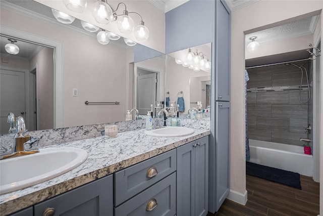 bathroom with hardwood / wood-style flooring, crown molding, and vanity