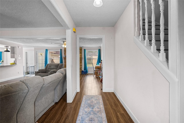 hallway with dark wood-type flooring and a textured ceiling