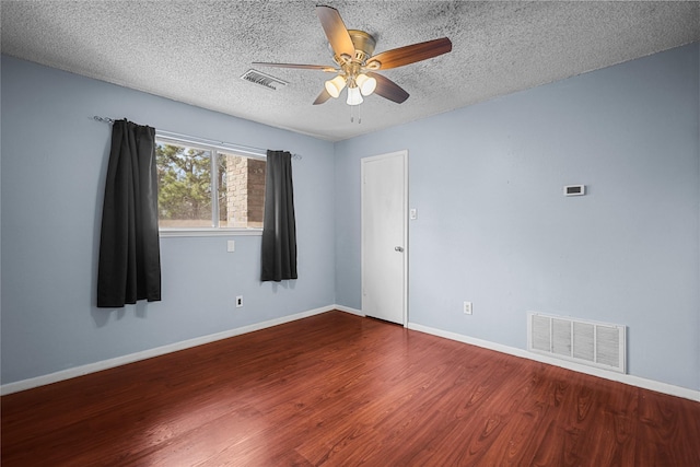 spare room featuring ceiling fan, hardwood / wood-style floors, and a textured ceiling