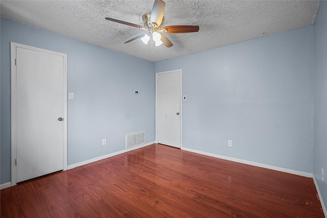 spare room with ceiling fan, wood-type flooring, and a textured ceiling