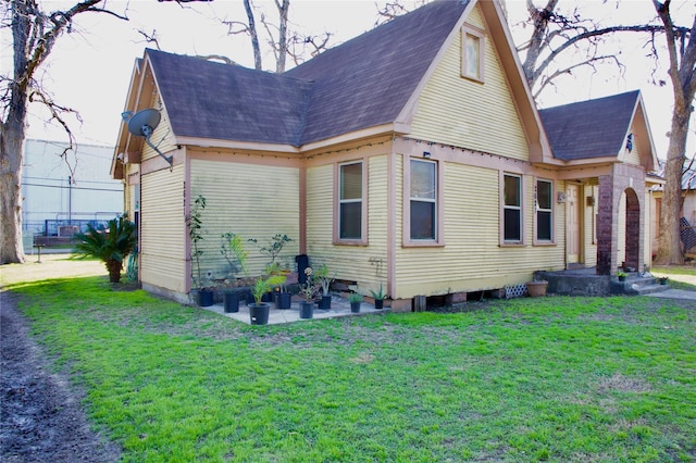 rear view of property with a patio and a yard