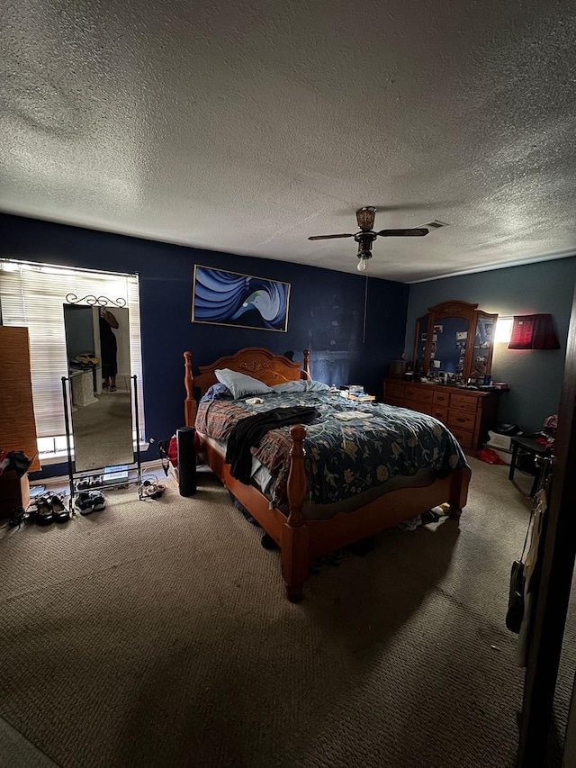 bedroom featuring carpet flooring, a textured ceiling, and ceiling fan