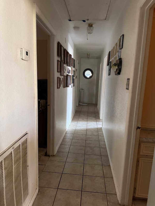 corridor with light tile patterned floors