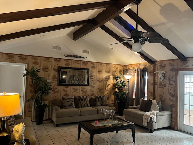 living room featuring ceiling fan, lofted ceiling with beams, and light tile patterned floors