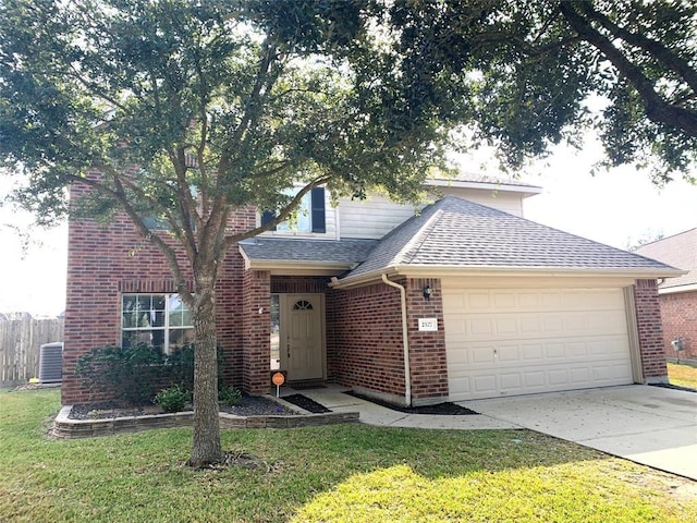 front of property featuring a garage, a front yard, and central AC unit