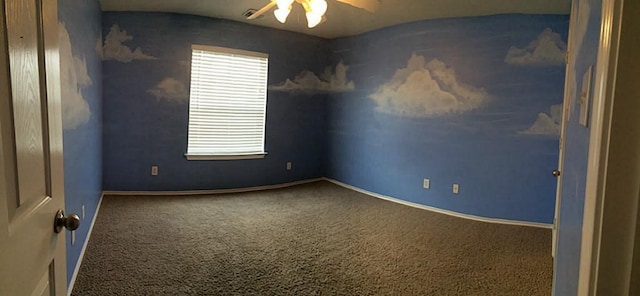 carpeted spare room featuring ceiling fan and a wealth of natural light