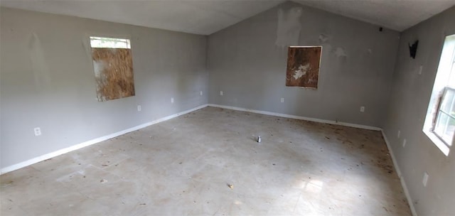 spare room with lofted ceiling