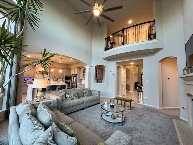 carpeted living room with ornate columns