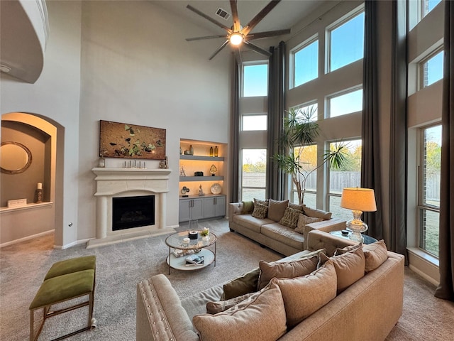 carpeted living room with a high ceiling