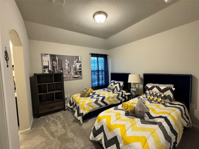 bedroom featuring carpet flooring and a textured ceiling