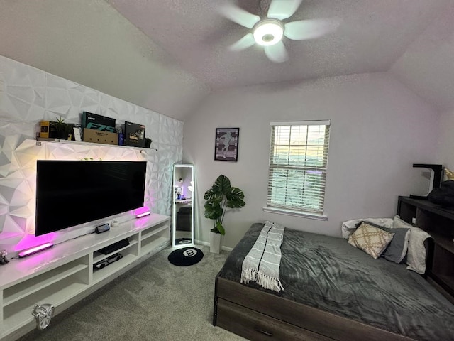 carpeted bedroom featuring ceiling fan, lofted ceiling, and a textured ceiling