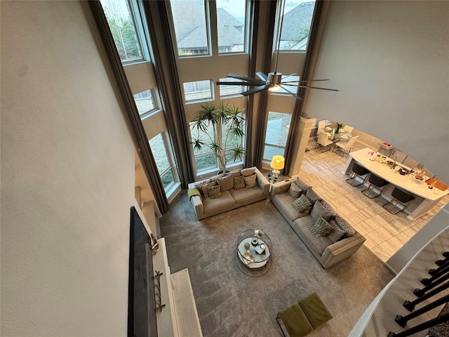 unfurnished living room with a towering ceiling and carpet floors