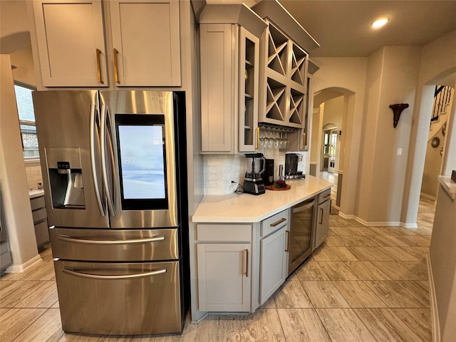 kitchen featuring gray cabinets, appliances with stainless steel finishes, and backsplash