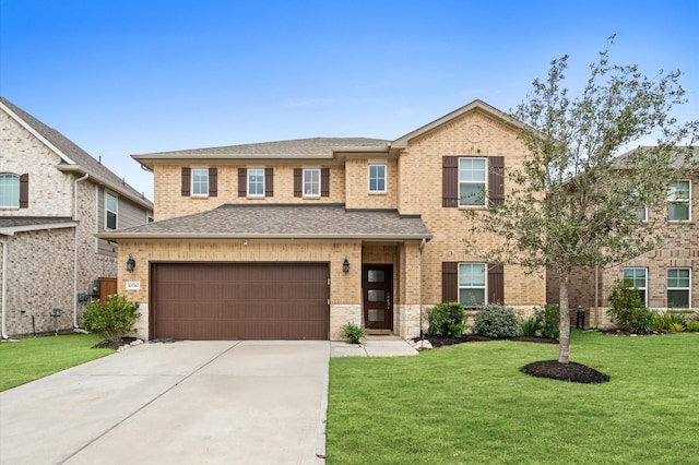 view of front of property with a garage and a front yard