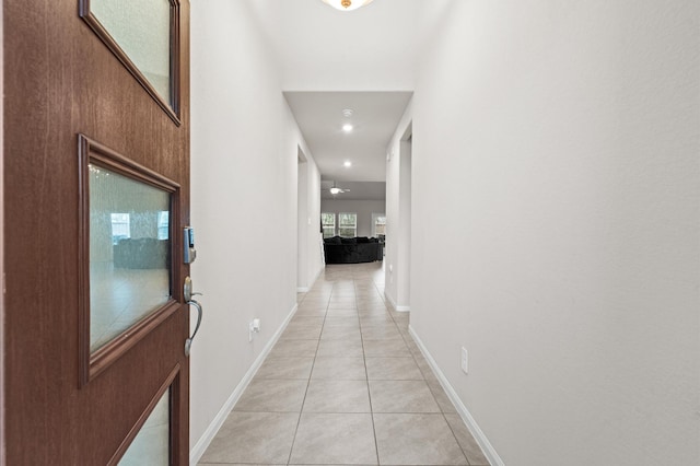 hall featuring light tile patterned floors