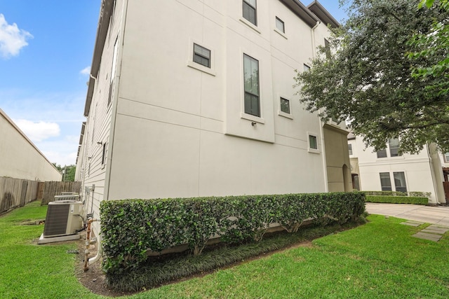 view of home's exterior featuring a lawn and central air condition unit