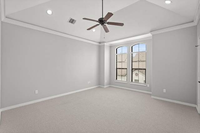 spare room with crown molding, light colored carpet, a raised ceiling, and ceiling fan