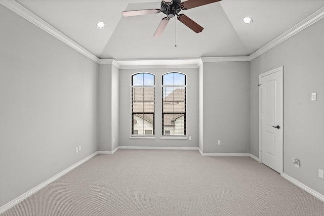 carpeted spare room featuring vaulted ceiling, ceiling fan, and crown molding