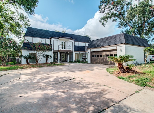 view of front of house featuring a garage and cooling unit