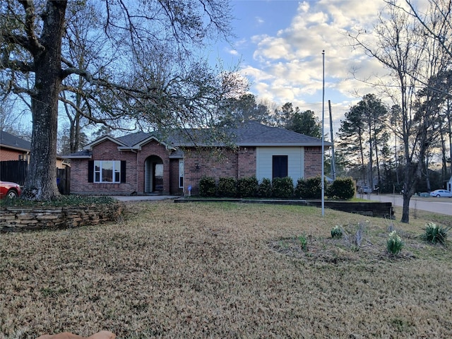 ranch-style home with a front lawn