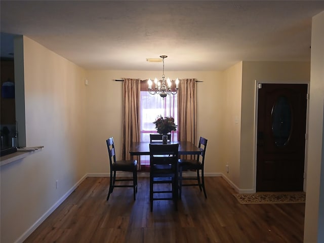 dining room featuring a notable chandelier and dark hardwood / wood-style floors