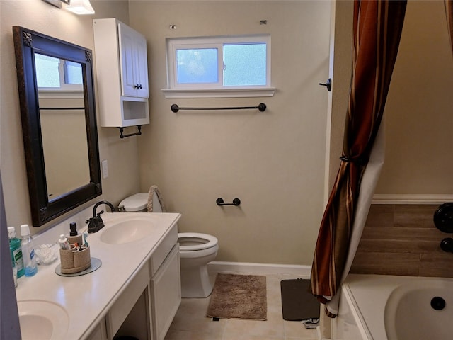 bathroom with tile patterned flooring, a bathing tub, vanity, and toilet