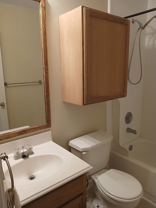 full bathroom featuring tiled shower / bath, vanity, and toilet