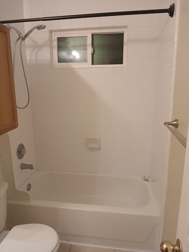 bathroom with toilet and tiled shower / bath combo