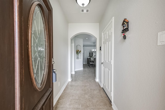 hall featuring light tile patterned floors