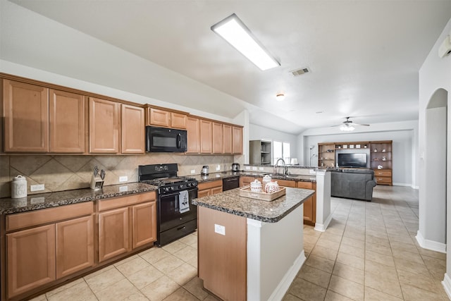 kitchen with black appliances, lofted ceiling, decorative backsplash, light tile patterned floors, and kitchen peninsula