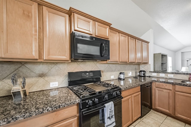 kitchen featuring vaulted ceiling, tasteful backsplash, dark stone countertops, light tile patterned floors, and black appliances