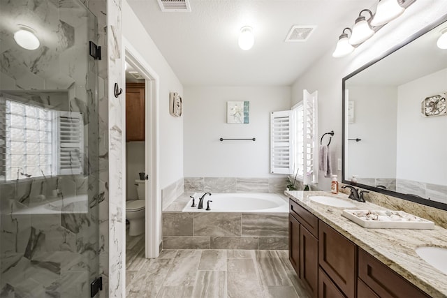 full bathroom with vanity, toilet, and separate shower and tub