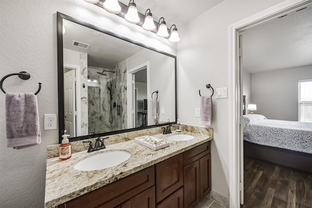 bathroom featuring vanity, hardwood / wood-style floors, and walk in shower