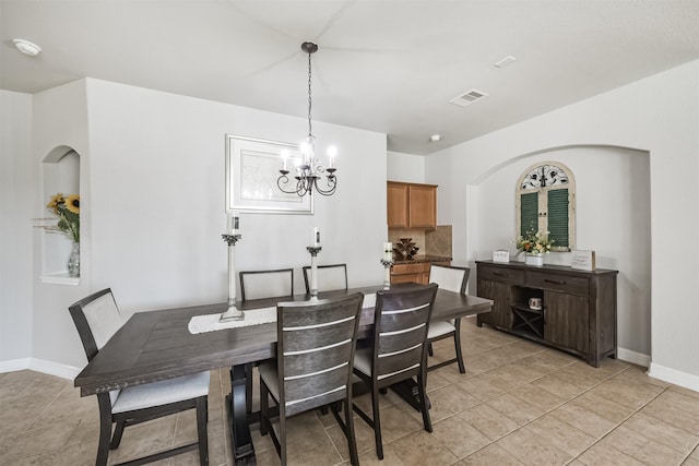 tiled dining area with a notable chandelier