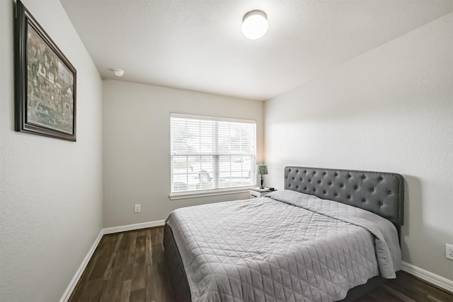 bedroom featuring dark hardwood / wood-style flooring