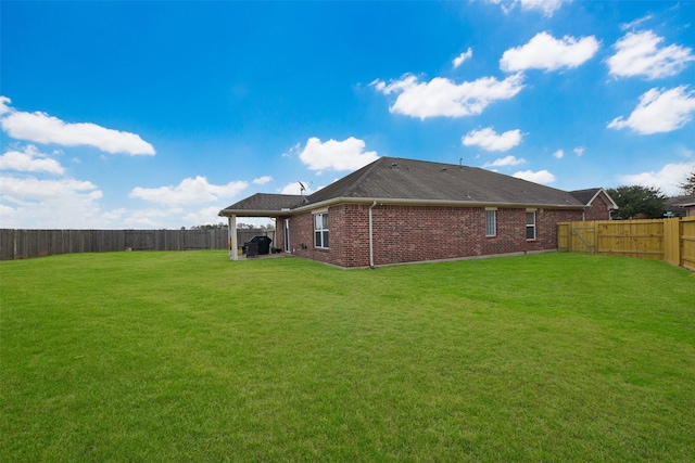 rear view of property featuring a yard