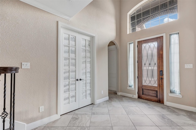 foyer featuring french doors and a high ceiling