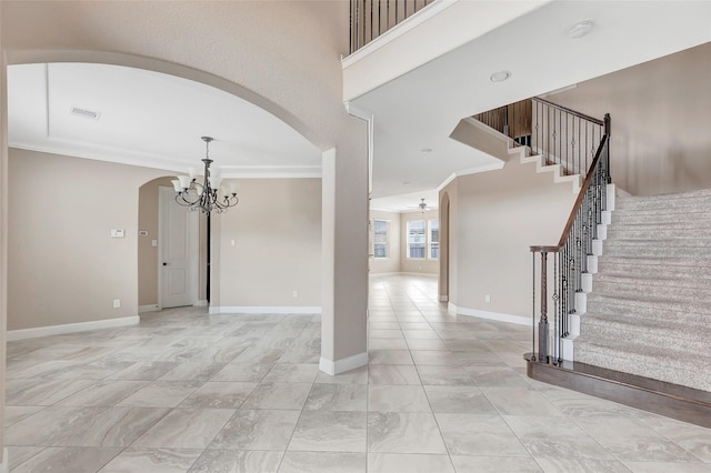 interior space with crown molding, a towering ceiling, and ceiling fan with notable chandelier