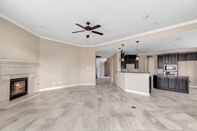 unfurnished living room with crown molding, ceiling fan, a premium fireplace, and sink