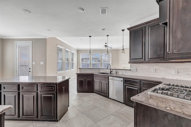 kitchen with sink, dishwasher, tasteful backsplash, a kitchen island, and decorative light fixtures