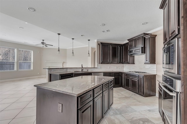 kitchen featuring a kitchen island, backsplash, hanging light fixtures, light stone counters, and stainless steel appliances