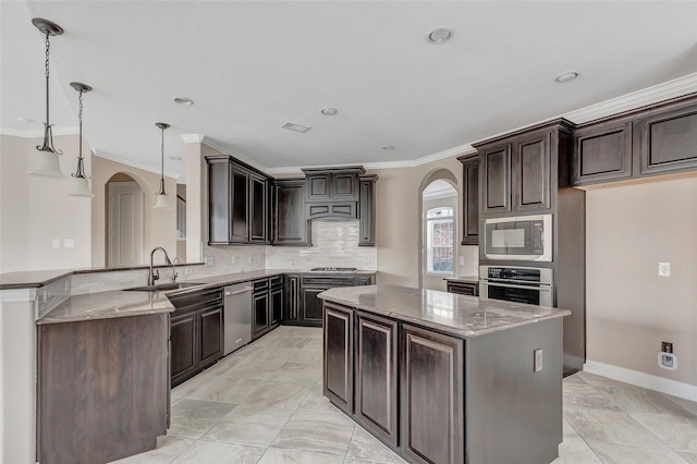 kitchen featuring dark brown cabinetry, stainless steel appliances, kitchen peninsula, and hanging light fixtures