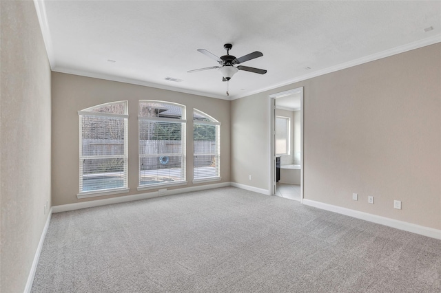 unfurnished room with crown molding, light colored carpet, and ceiling fan