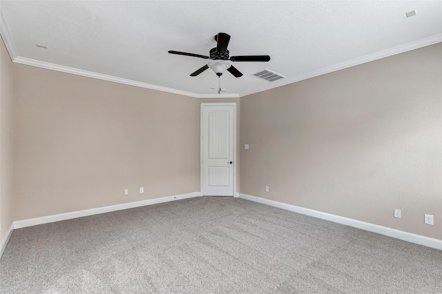 spare room featuring crown molding, ceiling fan, and carpet flooring