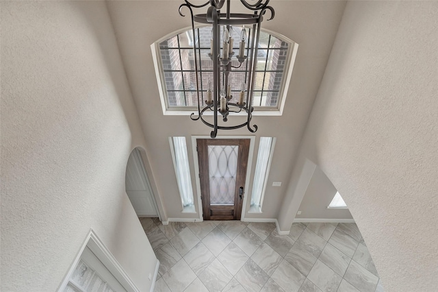 foyer entrance featuring a chandelier